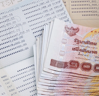 A Stack Of Cash Resting On An Open Passport
