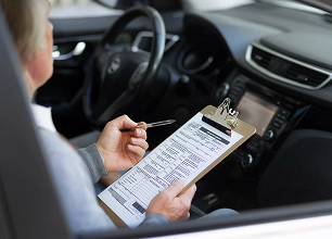 A woman sitting in the driver's seat of a car
